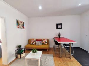 a living room with a couch and a table at Red Passion Apartment in Lisbon