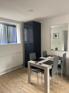 a dining room with a table and chairs at City apartments college street in Hull