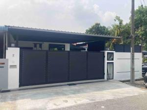 a garage with a black and white fence at Abbie's Private Pool Villa Bukit Mertajam Penang in Bukit Mertajam