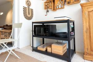 a black shelf with a microwave on a wall at The 98 Place Carcavelos in Carcavelos