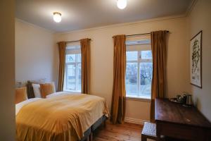 a bedroom with a bed and a large window at Hotel Aldan - The Bank in Seyðisfjörður