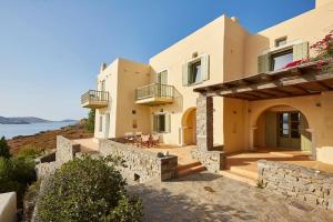 a house with a view of the ocean at Ochre Dream, Beach front & Sunset villa Naousa in Naousa