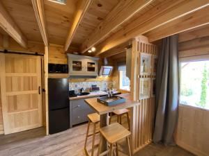 a kitchen with a small island in a tiny house at La Maison de Manolie in Courcelles-Sapicourt