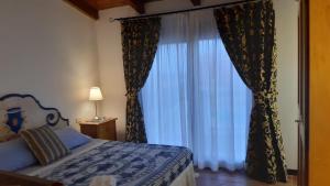 a bedroom with a bed and a large window at Casa Logos Stintino - Private pool in Stintino +57 photos