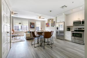 a kitchen and living room with a table and chairs at Stunning Condo 5-minute Walk to Bourbon street! in New Orleans