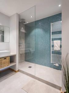 a bathroom with a glass shower and a sink at Renovated 2 Bedroom Apartment with Parking & AC in Luxembourg