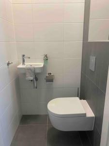 a bathroom with a toilet and a sink at New and modern apartment in the city center in Maastricht