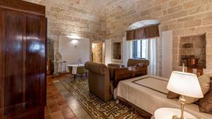 a bedroom with a bed and a sink in a room at MASSERIA TARSIA INCURIA 8&4, Emma Villas in Conversano