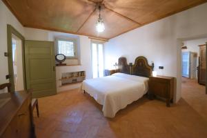 a bedroom with a large bed and a wooden ceiling at Piano nobile al Roseto del Drago in San Bernardo