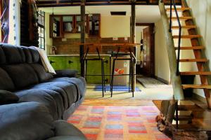 a living room with a couch and a kitchen at The Murana Chalet in Nanyuki