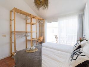 a bedroom with a large white bed and a book shelf at Casa Velero to 100mt from beach , optical fiber in La Oliva +34 photos
