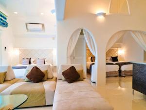 a bedroom with two beds and a glass table at Yuki Suite Kourijima in Nakijin