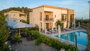 an external view of a villa with a swimming pool at Kannas Mani Luxury Suites -Adults Friendly 14 Plus in Stoupa
