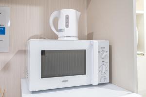 a microwave with a coffee pot on top of it at NEW OPEN! Nearest JR Shinokubo and JR soubu line HIgashinakano, shinjuku 5 minute ginza 25 minute asakusa 35 minute in Tokyo