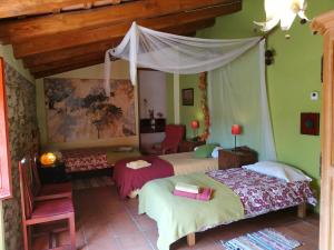 a bedroom with two beds and a canopy at Mas Can Puig de Fuirosos in Barcelona