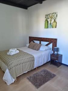 a bedroom with a bed and a nightstand with a bed sidx sidx at Posada Don Manuel in Paso de los Toros