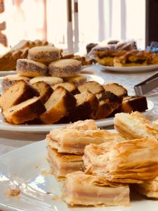 a table topped with plates of pastries on plates at Posada Don Manuel in Paso de los Toros