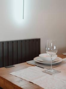 a wine glass sitting on top of a wooden table at Brecon Cottage A Luxury Hikers Retreat in Brecon