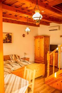 a bedroom with a bed and a table in a room at Nosztalgia Vendégház in Zalaegerszeg