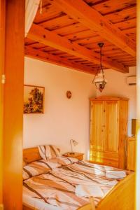 A bed or beds in a room at Nosztalgia Vendégház