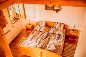 A bed or beds in a room at Nosztalgia Vendégház