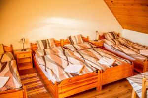 A bed or beds in a room at Nosztalgia Vendégház
