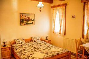 A bed or beds in a room at Nosztalgia Vendégház