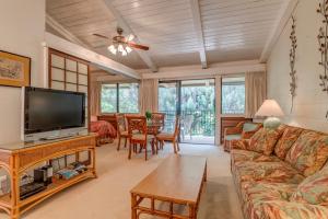 a living room with a couch and a tv at Hono Kai C12 in Maalaea