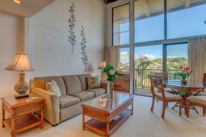 a living room with a couch and a table at Hono Kai C8 in Wailuku