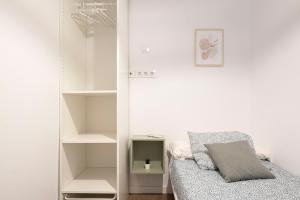 a room with a closet with a bed and shelves at APARTMENT BEACH PICASSO in Sant Adria de Besos