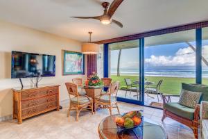 a living room with a view of the ocean at Papakea F105 in Lahaina