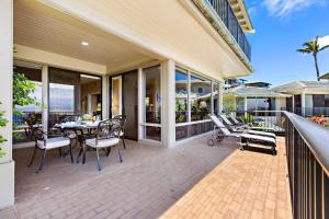 a patio with a table and chairs on a balcony at Kapalua Bay Villa 24G2 in Honokahua