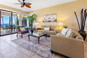 a living room with a couch and a table at Kapalua Bay Villa 24G2 in Honokahua