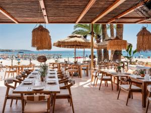 un ristorante sulla spiaggia con tavoli e sedie di Zel Mallorca a Palmanova