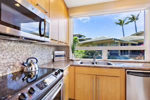a kitchen with a stove and a sink and a window at Kapalua Bay Villa 24G2 in Kahana