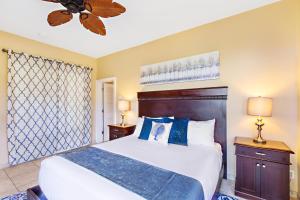 a bedroom with a bed and a ceiling fan at Kapalua Bay Villa 24G2 in Kahana +33 photos