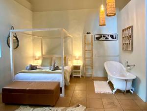 a bedroom with a bed and a bath tub and a bed and a tub at Pat Busch Mountain Reserve in Robertson