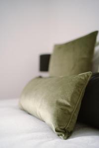 a pillow sitting on top of a bed at Green Flat Düsseldorf First in Düsseldorf