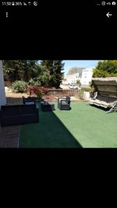 a picture of a yard with chairs and grass at יחידות נופש ואירוח שרונה בגבעת אבני in Giv'at Avni