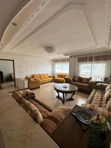 a large living room with couches and a table at Vaste appartement au centre de Tetouan in Tetouan