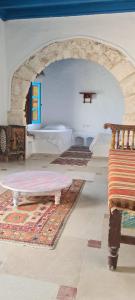a room with a couch and a bench in a room at Dar Michèle Djerba in Houmt Souk
