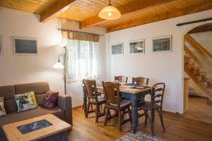 a living room with a table and chairs and a couch at Dom nad jeziorem Granicznym in Stary Żabin
