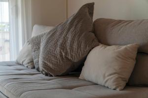 a bunch of pillows sitting on a couch at Milena Apartment Opatija in Volosko