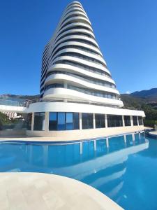 a building with a pool in front of it at Beach Pearl in Bečići