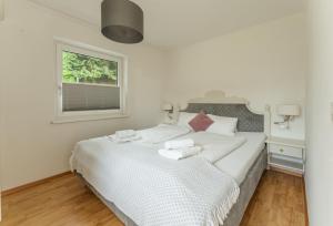 Postel nebo postele na pokoji v ubytování Kesselgrubs Apartements Ski & Badeglück + 14 fotografií