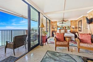 a bedroom with a bed and a balcony at Hololani A402 in Kahana