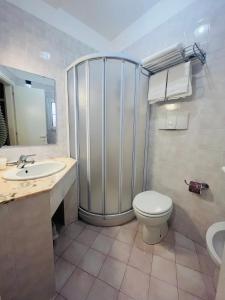 a bathroom with a shower and a toilet and a sink at Hotel Ristorante Montenerone Il Poeta in Apecchio +57 photos