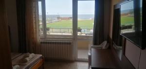 a room with a window with a view of a field at Guest House D. Bogdanova in Obzor +26 photos