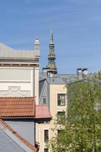 a view of a building with a tower in the background at Romantic and spacious apartment in Riga Old Town in Rīga