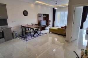 a living room with a table and a couch at 70qm Apartment in Alanya, 2 Zimmer, Strandnähe in Alanya
